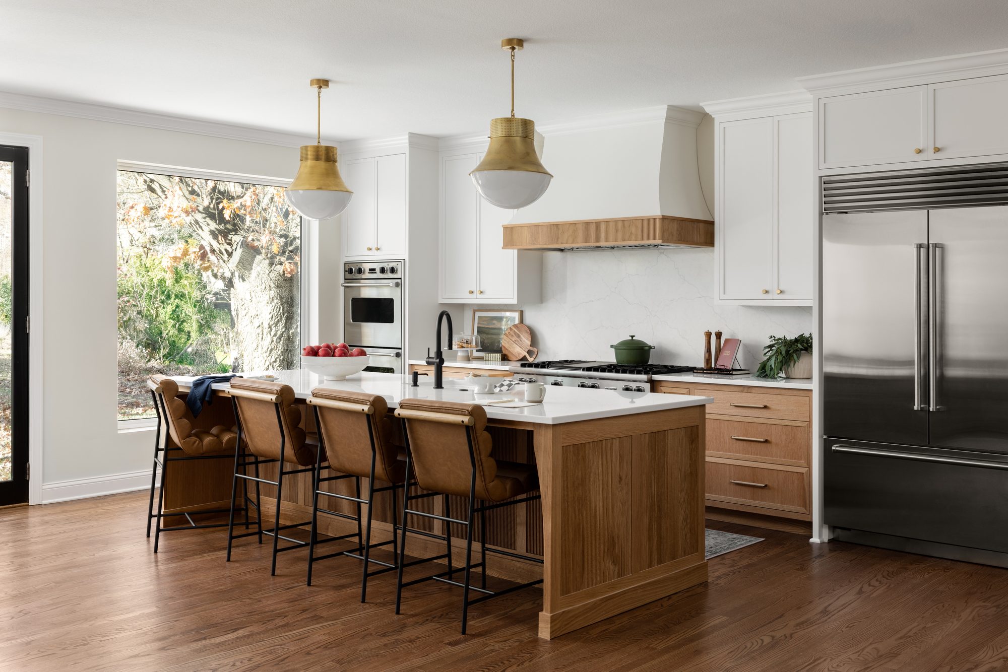 Via Villa — island with leather seating and custom wood cabinetry